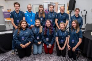 Members of the Young People's Forum. They're wearing matching YPF tops and standing/kneeling in two lines